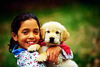Girl and Golden Retriever puppy