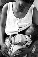 Black woman breastfeeding baby