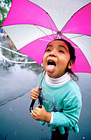 Girl catching raindrops