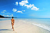 Nude woman walking on beach. Bahamas
