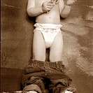 Two-year old boy with pants down wearing diapers