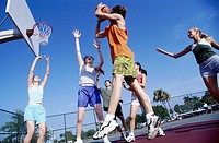 Girls and guys playing basketball