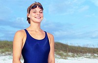 Woman with Swimsuit and Goggles on Beach Smiling