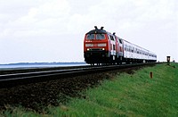 Regional train of Deutsche Bahn with diesel locomotive in double track on the Hindenburgdamm that connects Sylt island with the mainland. In the backg...