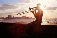 Silhouette of a trombone player on the Malecón. Havana, Cuba