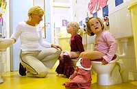 Children sitting on toilet