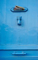 Blue door with letter drop and knocker. Cassis. France