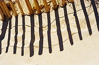 Shadow of wooden fence on sand. St-Tropez. France