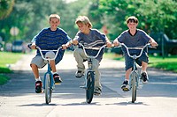 three kids riding their bikes