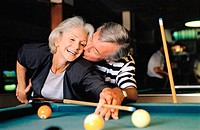 senior couple shooting pool