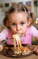 Nursery school. Gir eating spaghetti