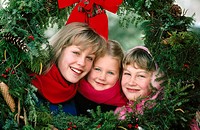 Sisters framed by Christmas wreaths