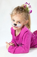Young girl with bodypaint, cat nose painted in face.