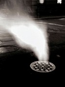 Steam pouring from a Manhole cover on New York´s Lower Eastside is caputed at night in a 2second time exposure. The resulting photo is ghostly and omi...