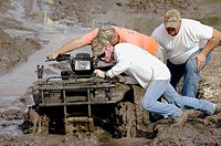 People with 4 wheelers and trucks on Sunday outing in the mud for fun and show of power and speed North FL
