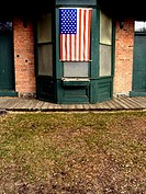 An American flag draps over a window of a rest station in a wilderness park. USA.