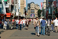 Germany, North Rhine Westphalia, Cologne. People walking in Schildergasse, a pedestrian street with many shop and restaurants in the city center