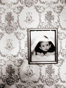 A photo of an infant child portriat is captured with a blurred effect.