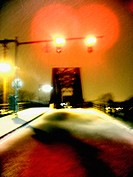 A train trestle is captured at night during the winter with fresh fallen snow.  Ghostly and mysterious.