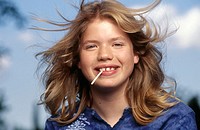 Headshot of Adolescent girl with Lollipop.