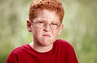 Headshot of Angry Redhead boy with Glasses