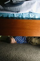Boy, 5, sleeping under his bed.