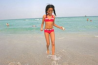 10-year-old biracial girl playing at beach. Miami Beach, Florida. USA.
