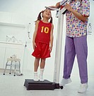 Young schoolgirl getting physical exam for playing school sports.