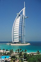 The 7 star luxury Burj al Arab Hotel seen from the grounds of the 5 Star luxury Jumeirah Beach Resort Hotel at Jumeirah Beach, Dubai, United Arab Emir...