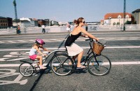 Mother and daughter on a tandem bike. Copenhagen. Denmark