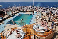 Lido Deck, Aft Pool, sauna, sunbathing. Holland America Line, MS Noordam. New York. USA.