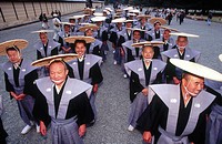 Men wearing flat woven straw hats in the Jidai Matsuri procession. Kyoto city. Kyoto. Japan.