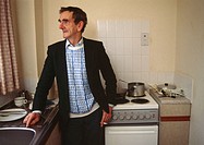 Middle aged man in his kitchen, Glasgow, Scotland. UK.