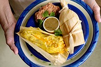 Vegetarian plate - cheese tamale and refried beans.