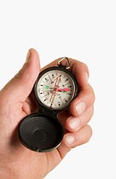Male caucasian hand holding compass