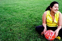 Latino woman holding soccer ball - football
