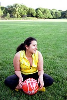 Latino woman holding soccer ball - football