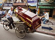 Man transporting a coffin on rickshaw. Hanoi. Vietnam.