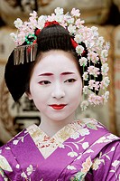Geisha in traditional make-up and wearing a kimono in the Gion district of Kyoto, Japan.