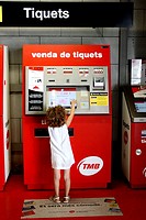 5 year old girl in front of ticket vending machine, Barcelona. Catalonia, Spain