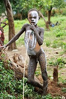 Make-up. Surma child. Near Kibish. Ethiopia.