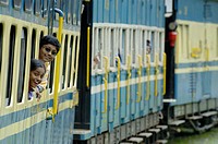 Loughing girls looking out of the train windows of the Nilgiri Mountain Railway driving from Coonoor to Ooty. Tamil Nadu, India 2005.  - Info: The Nil...