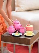girl playing tea house with toys
