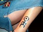A tattoo of the band Einstürzende Neubauten on a woman legs.
