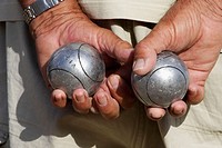 Hands with iron balls, Petanca game. Alicante. Comunidad Valenciana. Spain
