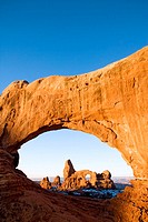 Turret Arch framed through North Window at sunrise, Arches National Park, Utah, USA.