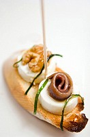 ´Montaditos´. Spanish canapé: cheese with nuts and anchovies.
