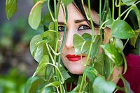 Woman looking through ivy