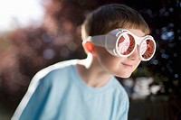 Boy, age 7, wearing big sunglasses.