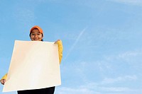 Woman holding a blank poster _ advertisement sign.